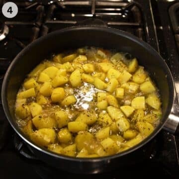 adding stock to potato cubes in a saucepan to help them cook.