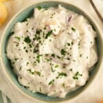 german herring salad with apples and onions in a small bowl.