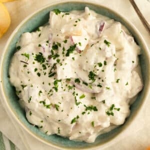 german herring salad with apples and onions in a small bowl.