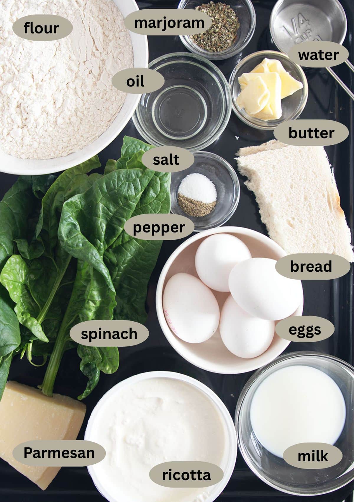 labeled ingredients to make italian pie with homemade crust, spinach and ricotta filling and eggs.