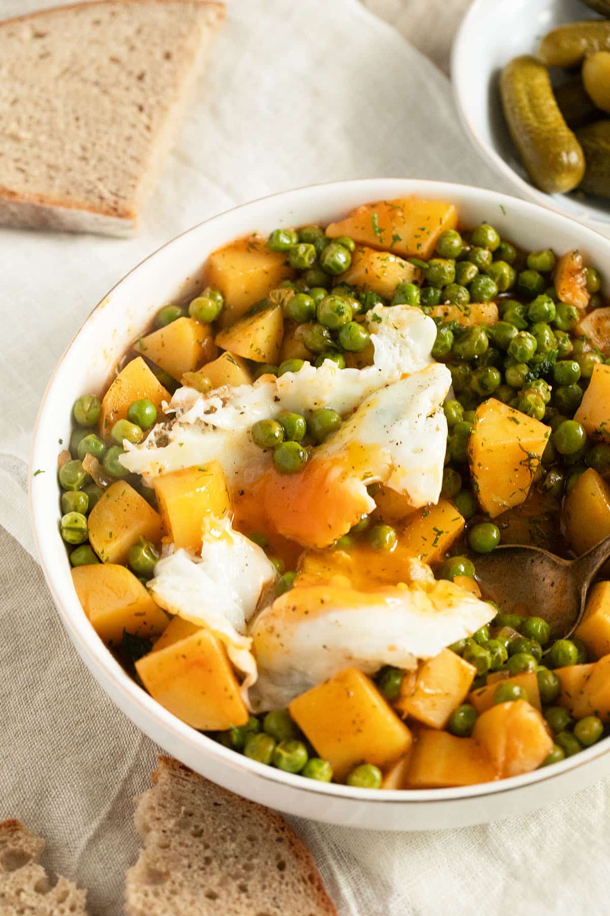 greek peas and potatoes with a fried egg on top.