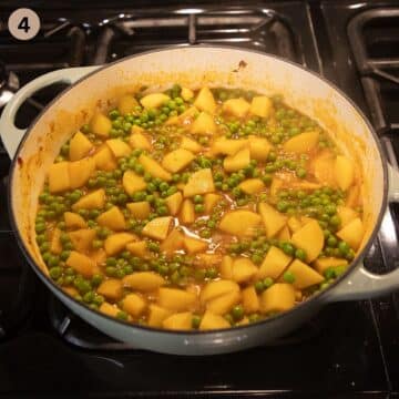 simmering greek pea and potato stew in a large pot.