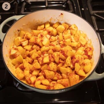 sauteing cubed potatoes, onions and tomato paste in a large pot to make stew.