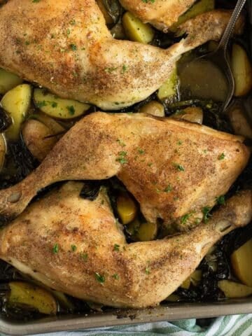 wild garlic chicken with small potatoes in a roasting tin.