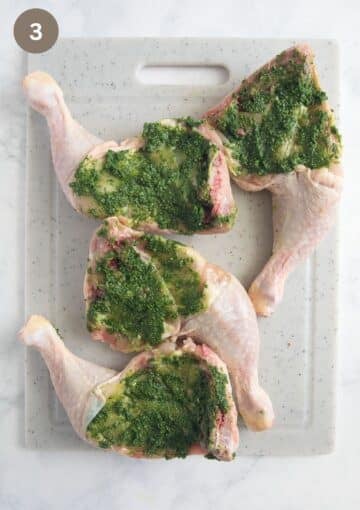 chicken quarters smeared with pesto on the underside before roasting.