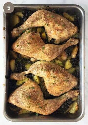 roasted chicken and wild garlic on potatoes in a roasting pan.