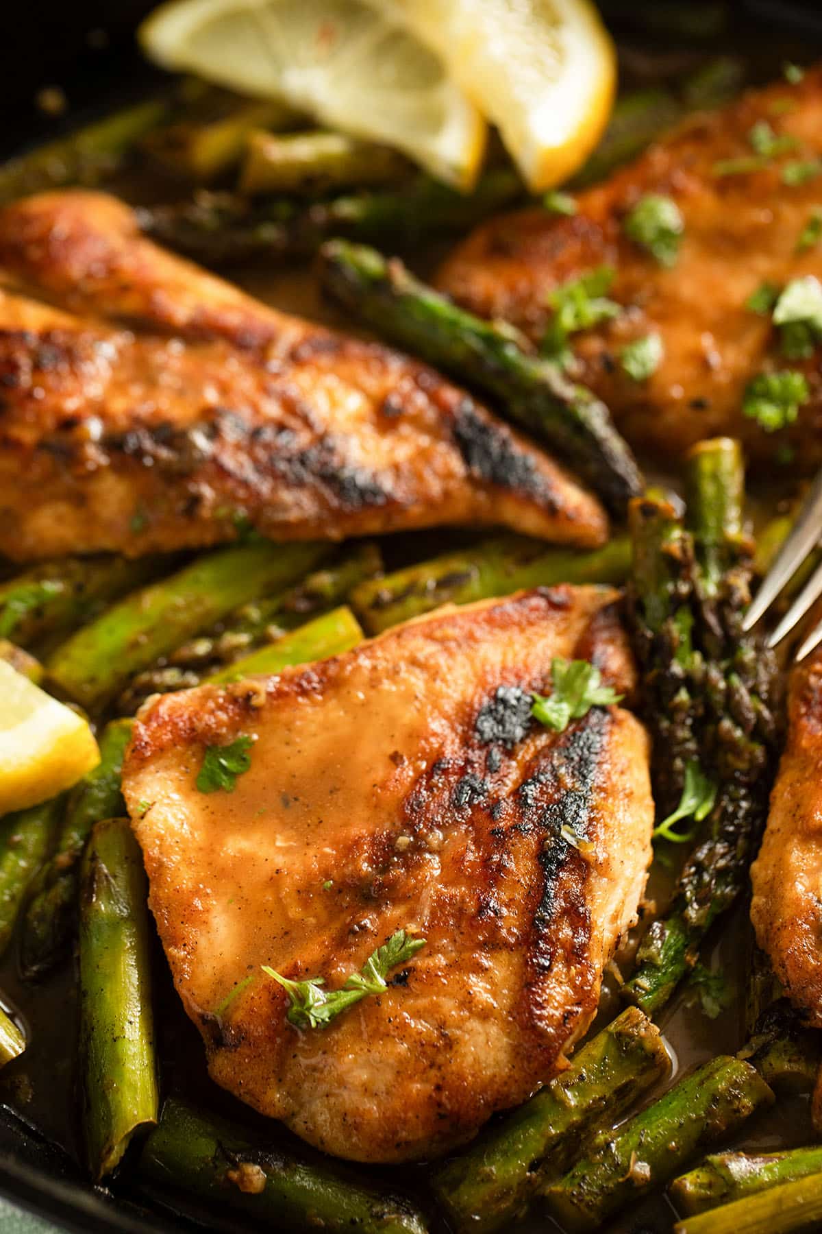 golden chicken breasts and asparagus in lemon sauce.