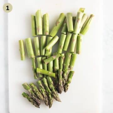 chopped asparagus on a cutting board.