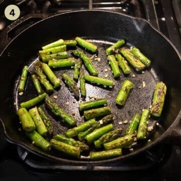 cooking green asparagus pieces in a skillet.