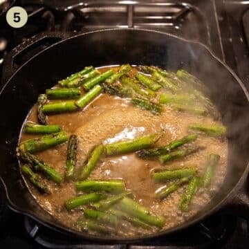 cooking asparagus pieces in chicken stock and lemon sauce.