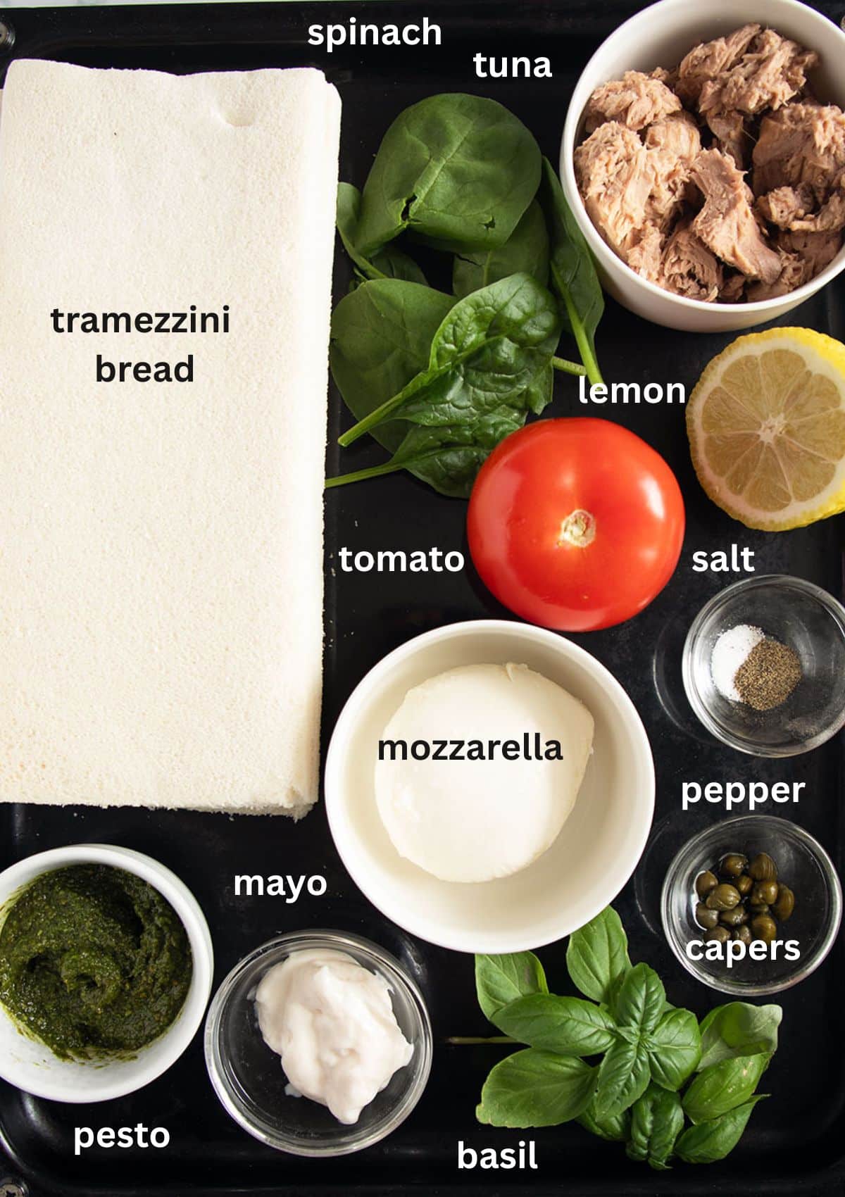 labeled ingredients for making tramezzini with tuna and tomato and mozzarella filling.