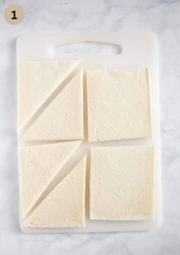 cutting white bread into triangles to make tramezzini sandwiches.