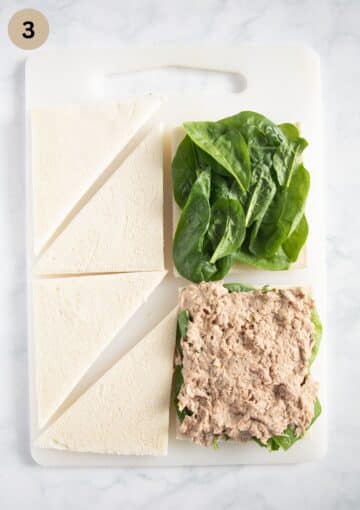 filling tramezzini with baby spinach leaves and tuna.