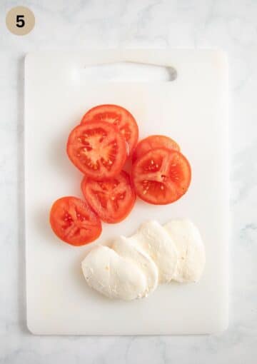 sliced tomatoes and mozzarella on a cutting board.