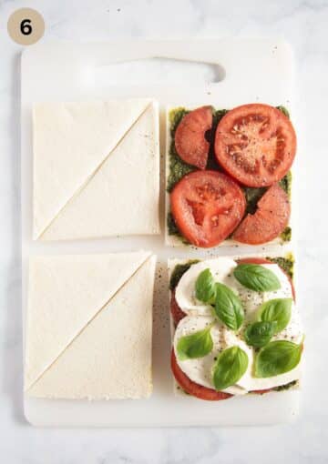 filling tramezzini with tomato and mozzarella sandwiches, and basil leaves.