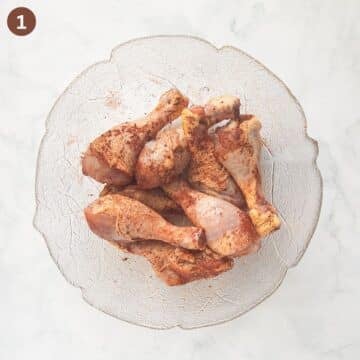 seasoned drumsticks in a large bowl.