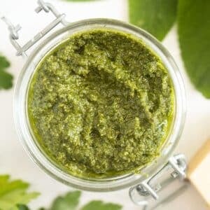 sage pesto with walnuts in a jar.