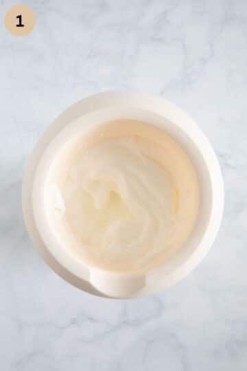 beated white cakes needed for cake batter in a mixing bowl.