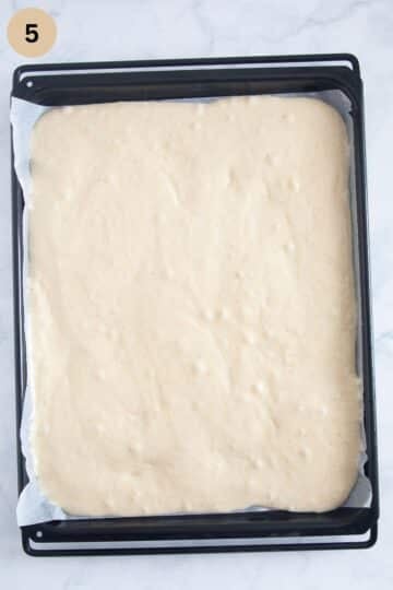 cake batter on a baking sheet before adding the cherries.