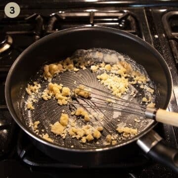whisking flour into melted butter in a saucepan with a whisk to make roux for kohlrabi.
