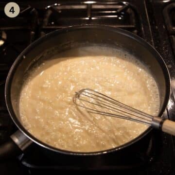 whisking white sauce for kohlrabigemüse in a saucepan.