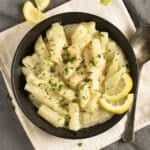 creamy german kohlrabi served in a bowl with lemon wedges.