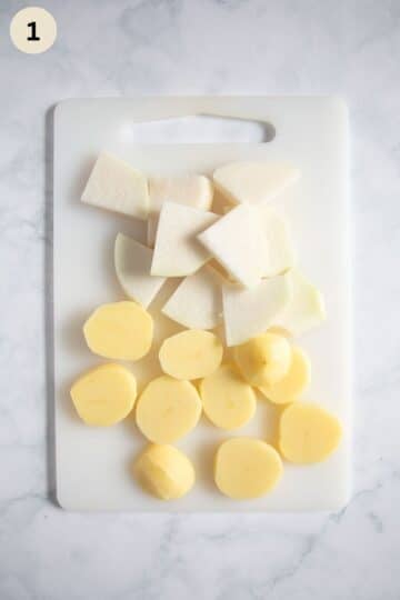 sliced kohlrabi and potato slices on a cutting board on a cutting board.
