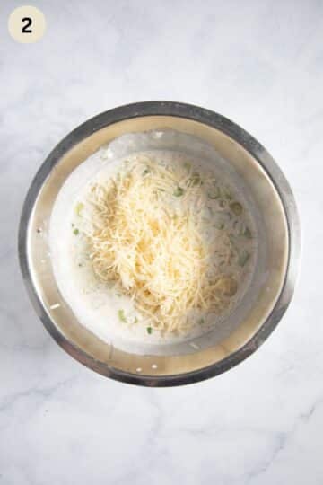 cream mixture with grated cheese for kohlrabi gratin in a bowl.