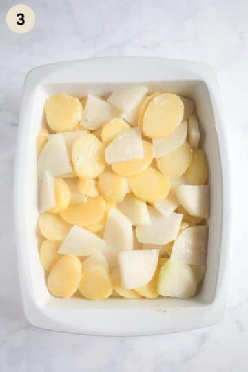 pre-cooked kohlrabi and potato slices in a casserole dish before adding the cream mixture.