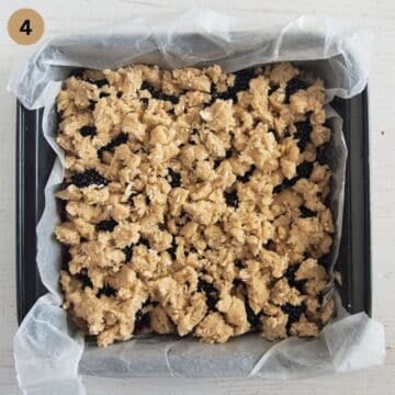 unbaked blackberry bars with crumbles in a square baking dish.