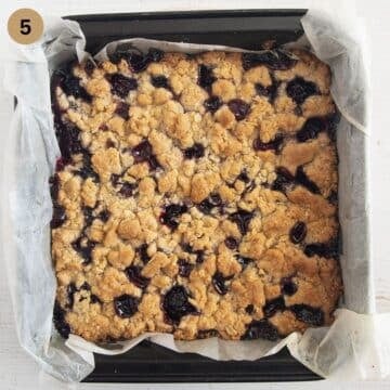 baked blackberry oat crumble bars in a square baking dish.