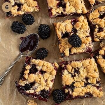 blackberry oat bars cut into pieces and some fresh blackberries. 