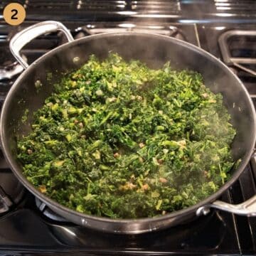 sauteing kale in a large pot.