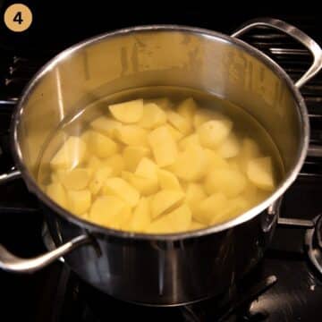 boiling potato cubes in a pot.