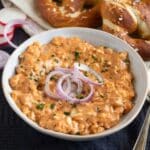 german obatzda recipe with red onions on top in a small bowl.