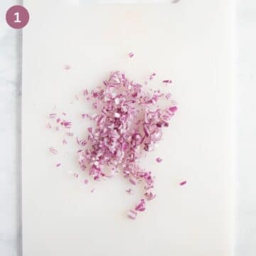 finely chopped onions for german dip on a cutting board.