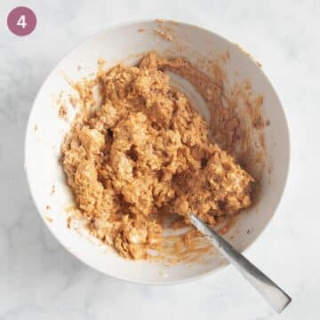 mixing obatzda ingredients with a fork in a bowl.