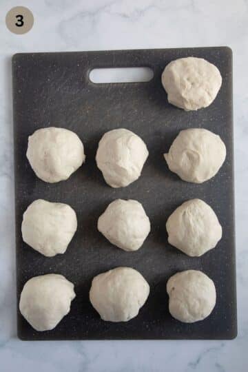 dough balls for making pretzels after rising on a cutting board.