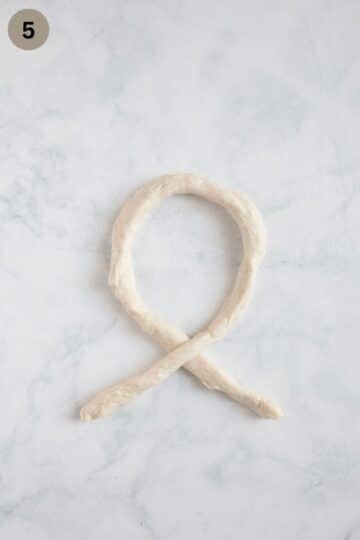 shaping a rope of dough to make pretzels.