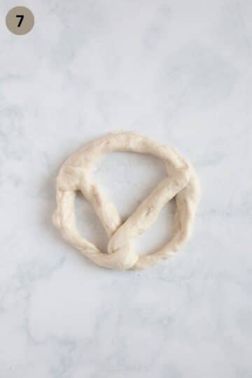 shaping a dough rope to make a pretzel.