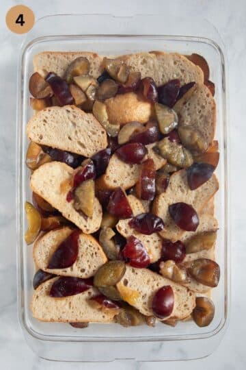 assembled but unbaked plum and bread pudding in the baking dish.