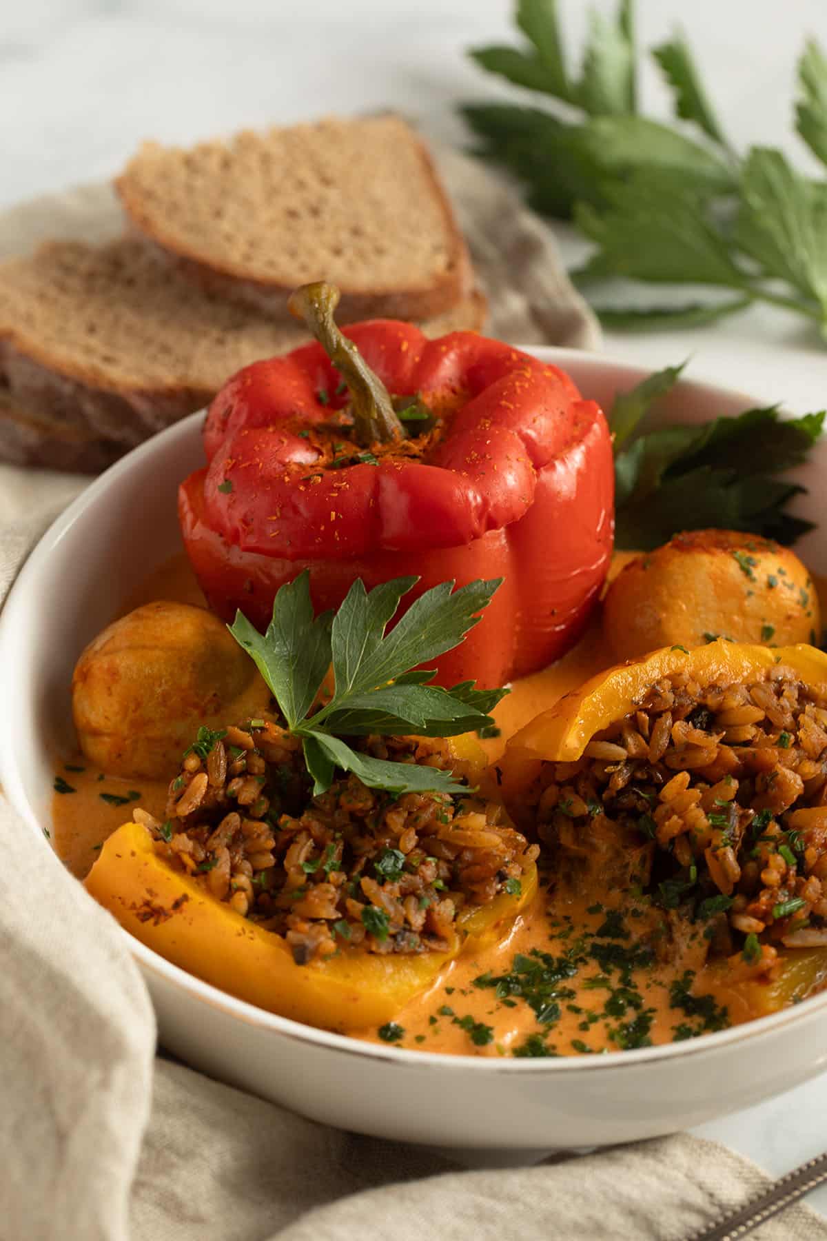 serving rice and mushrooms stuffed peppers with slices of bread.
