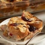 slices of plum bread pudding with a fork on a small plate.