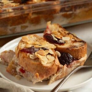 slices of plum bread pudding with a fork on a small plate.